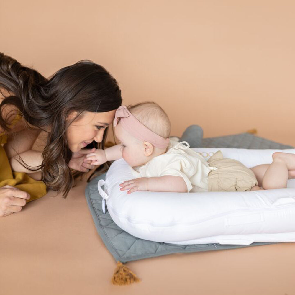 DockATotを使ってママと赤ちゃんが一緒にくつろぐシーン（ナチュラル背景）